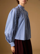 Side detail of Yana county Grey Blue Stripes Blouse with Wynona Chocolate Corduroy skirt by Thierry Colson