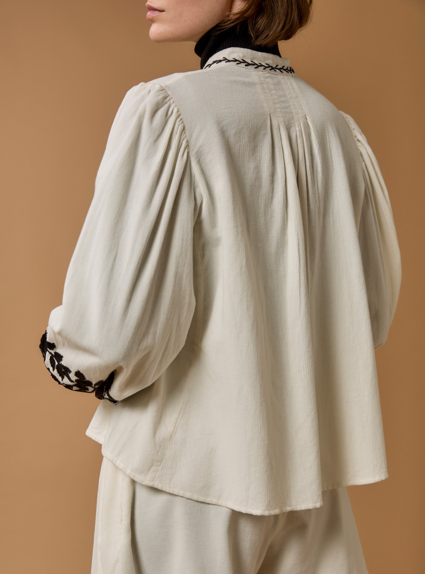 Back view of Yana corduroy Cream Blouse with black embroidered by Thierry Colson