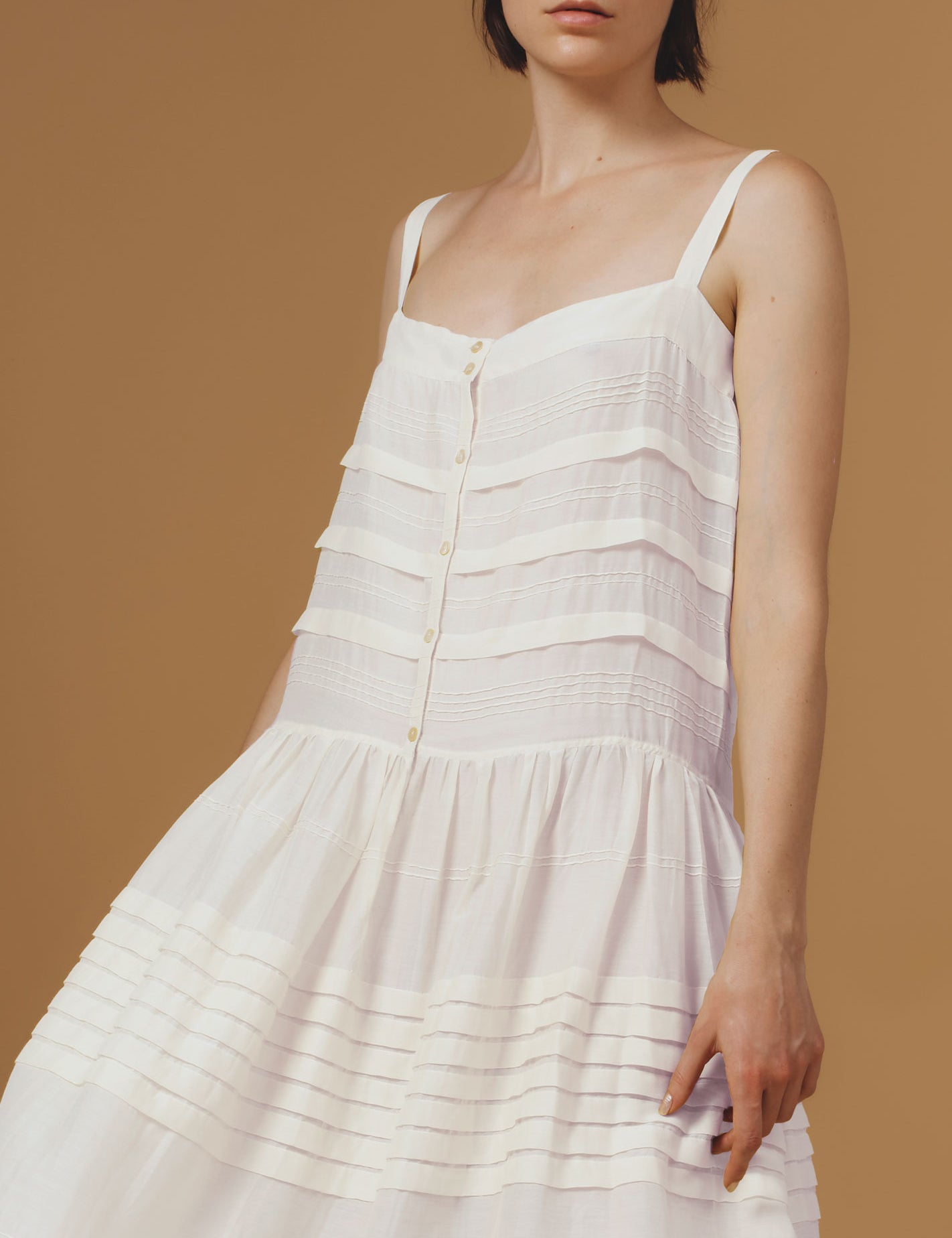 Detail of Zafiria Optical Pleats Off White dress by Thierry Colson