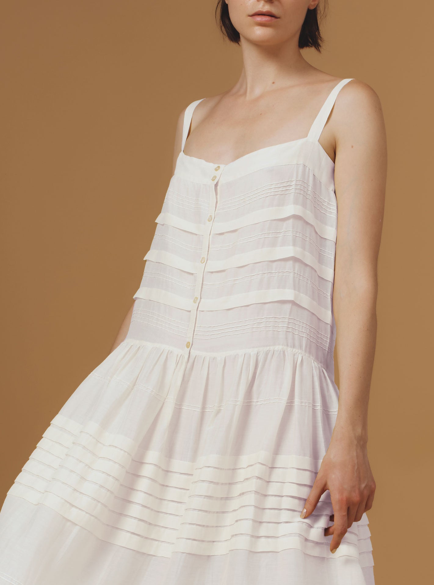 Detail of Zafiria Optical Pleats Off White dress by Thierry Colson