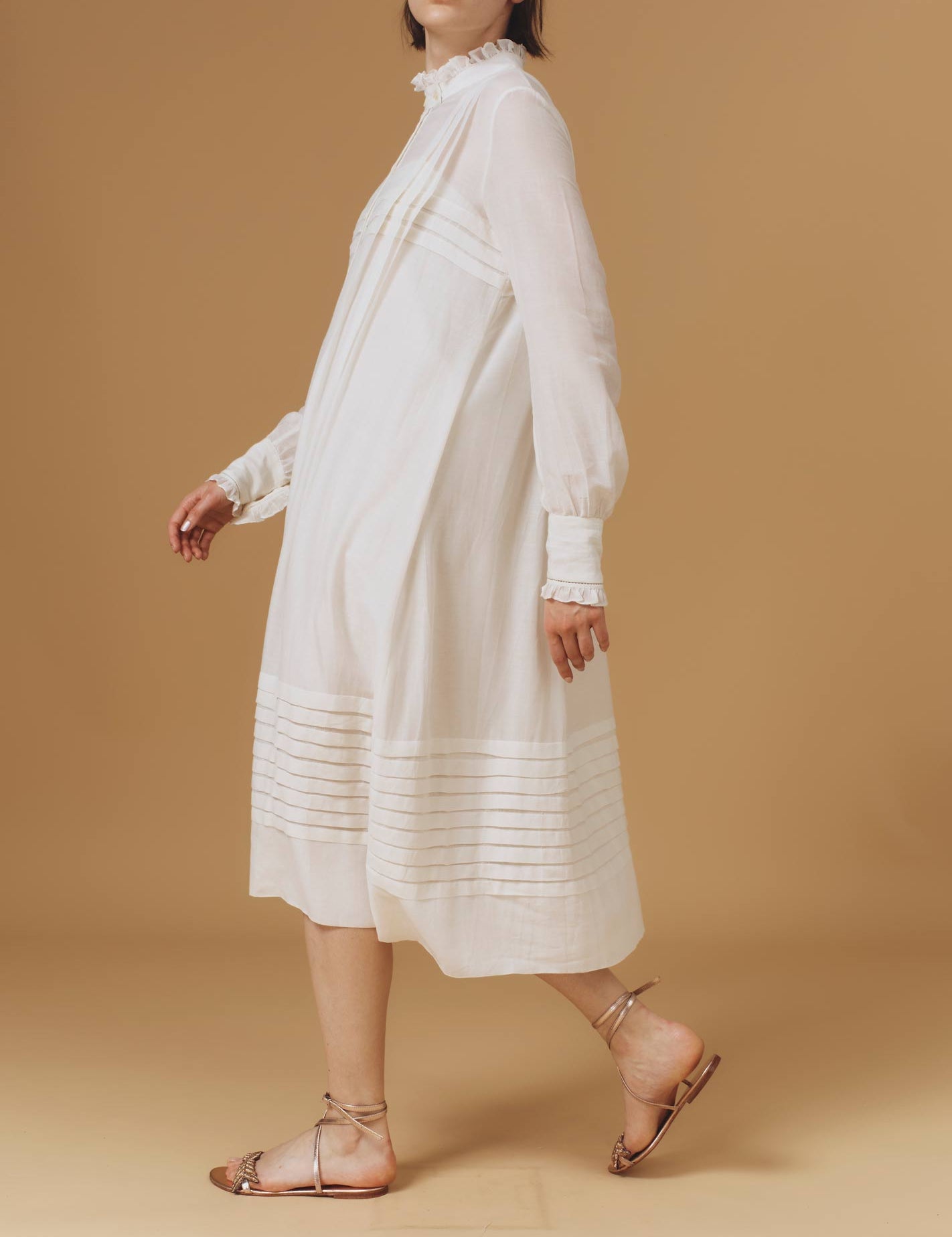 Side of Zita Optical Pleats Off White dress by Thierry Colson