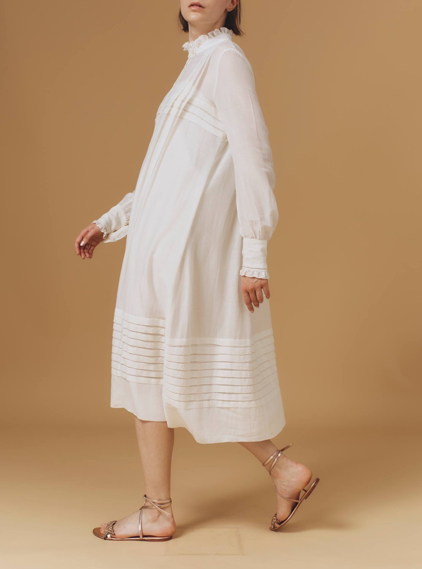 Side of Zita Optical Pleats Off White dress by Thierry Colson