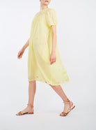 Side left  view of Olympia Sweet Lemon cotton Dress by Thierry Colson