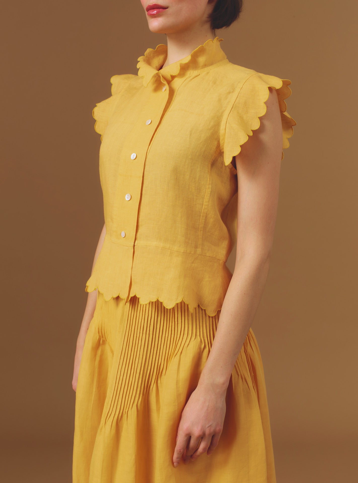 Side view of Yael Barocco Scallops Sunflower Vest by Thierry Colson